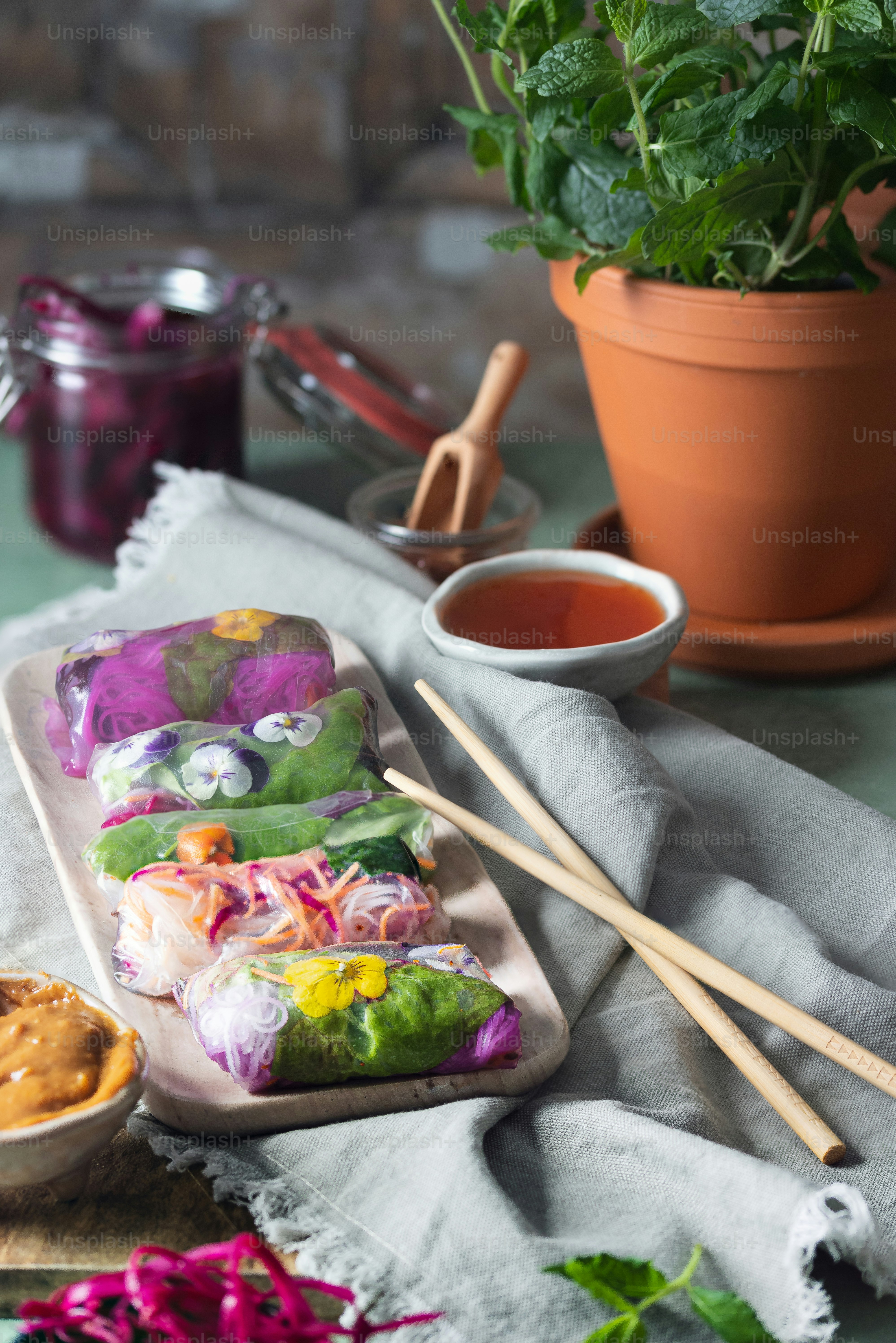 a plate of food sitting on a table next to a potted plant