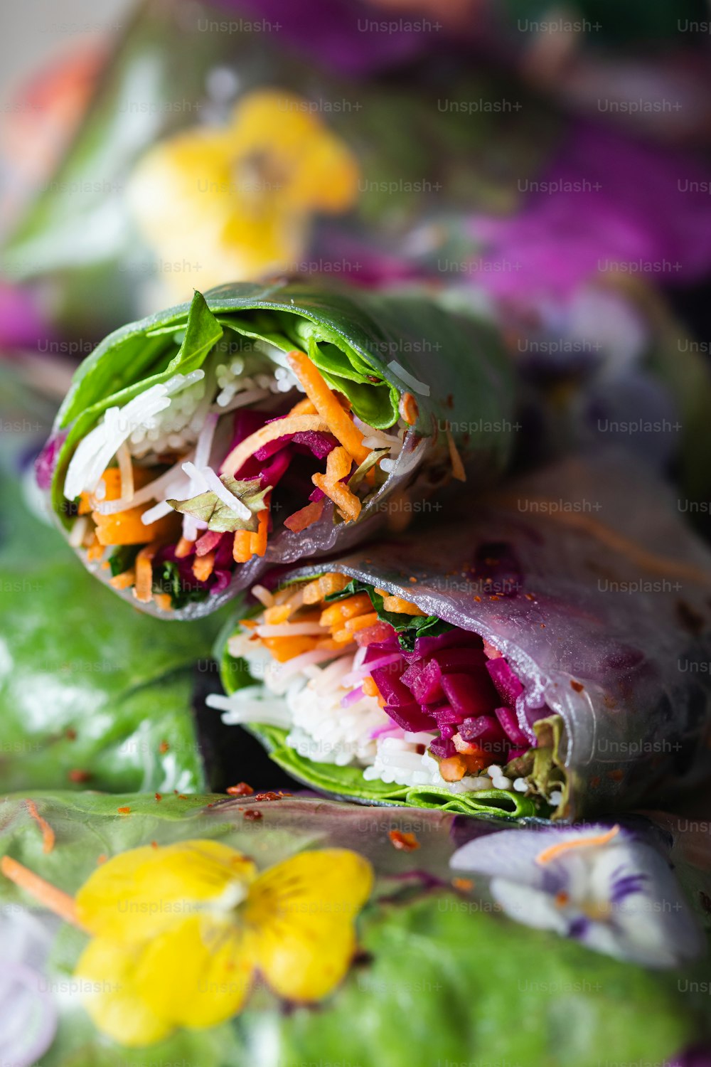 a wrap filled with lots of veggies on top of a table