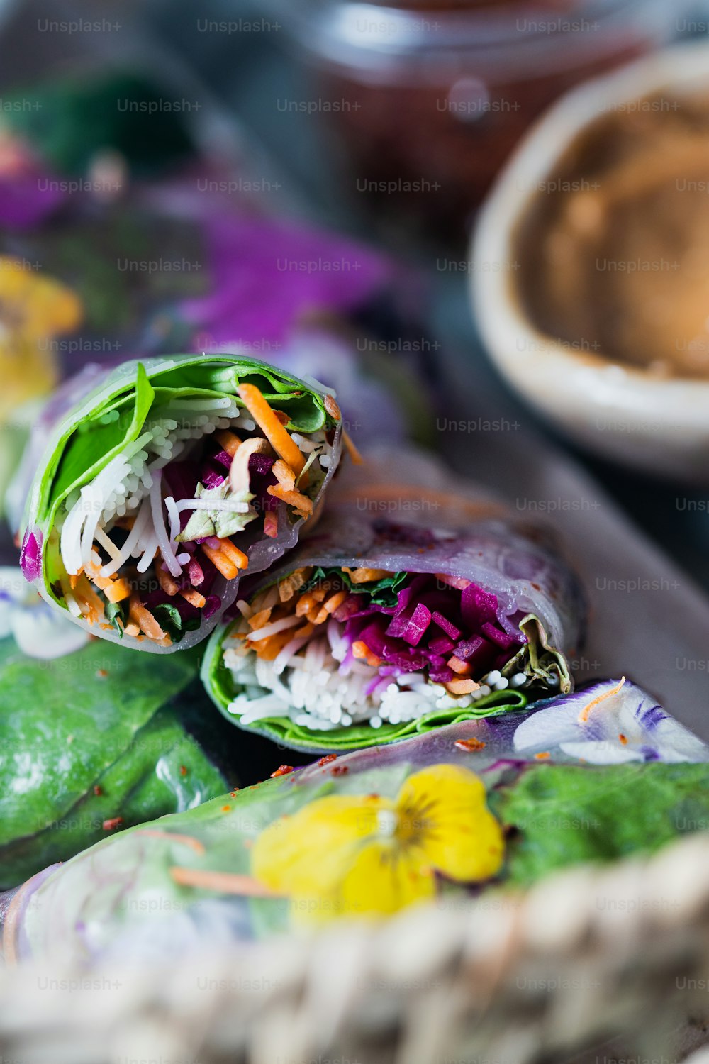 a plate of food with a wrap and a bowl of dipping sauce