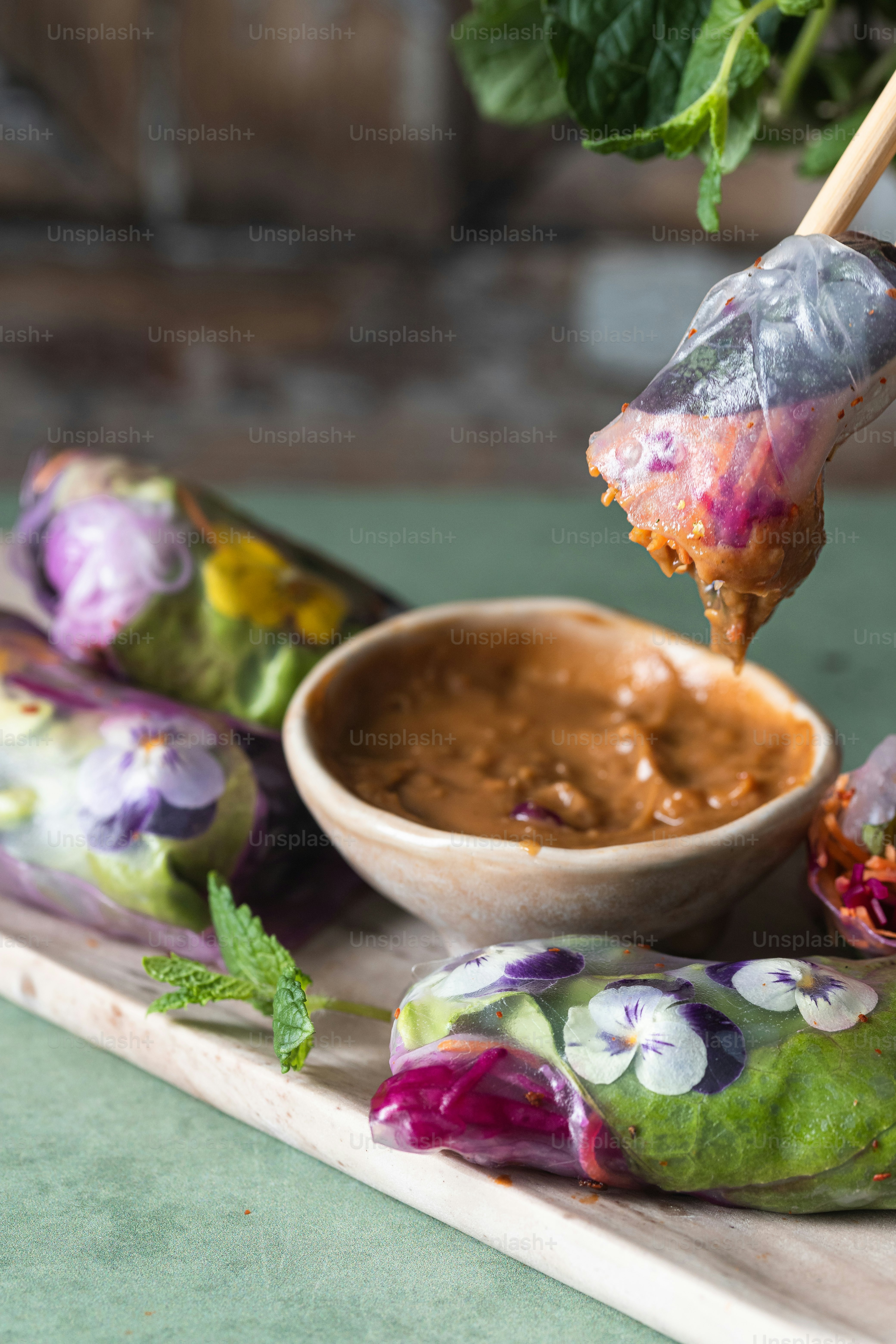 a wooden tray topped with food and dipping sauce