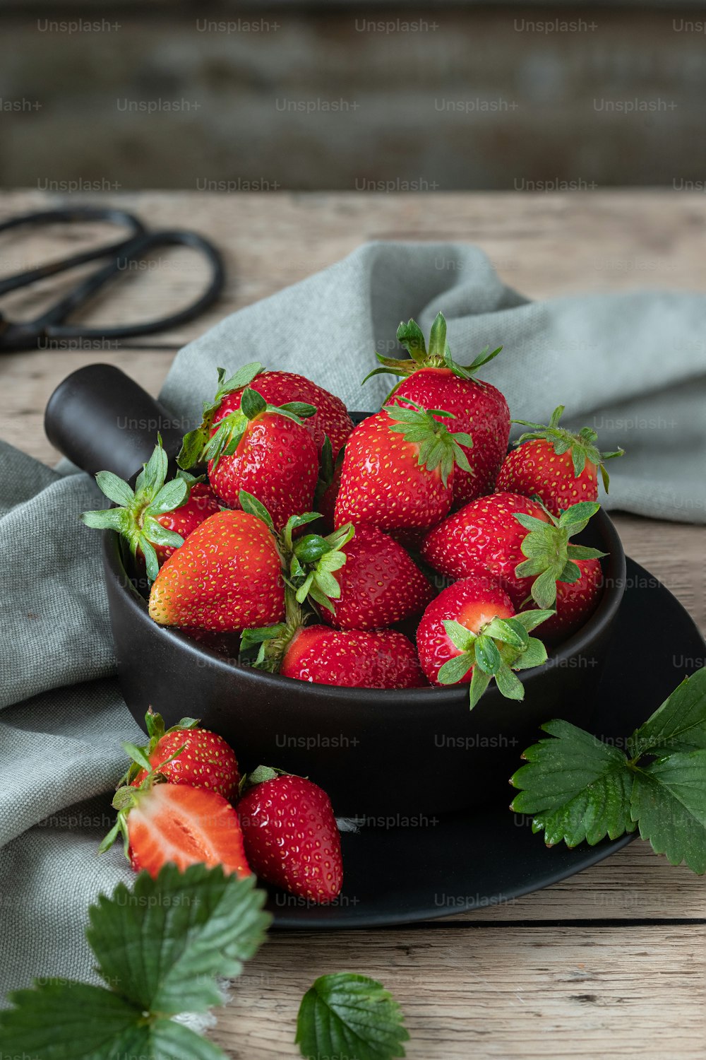 a bowl full of strawberries on a table