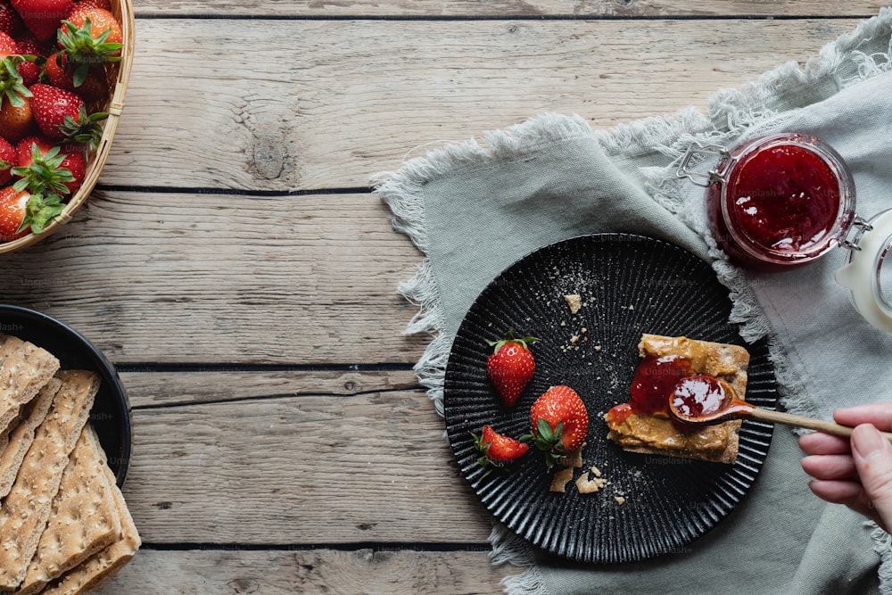 a plate of strawberries and crackers on a table