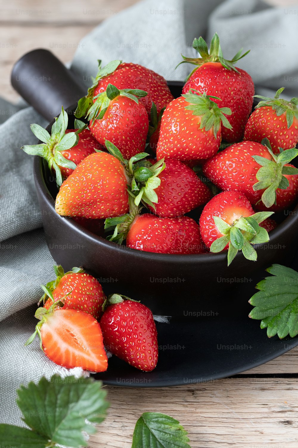 a bowl full of strawberries on a table