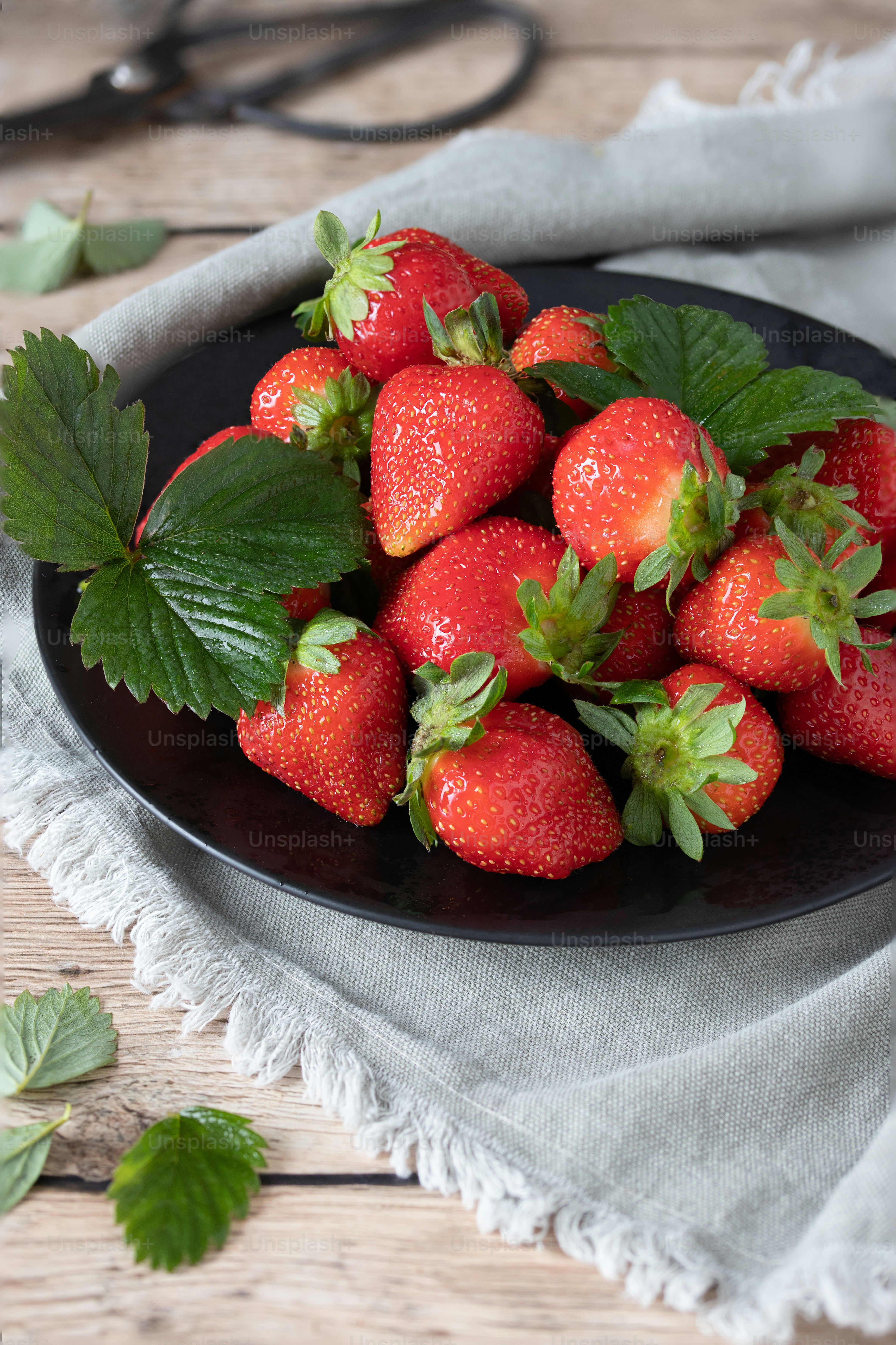 a plate full of strawberries on a table