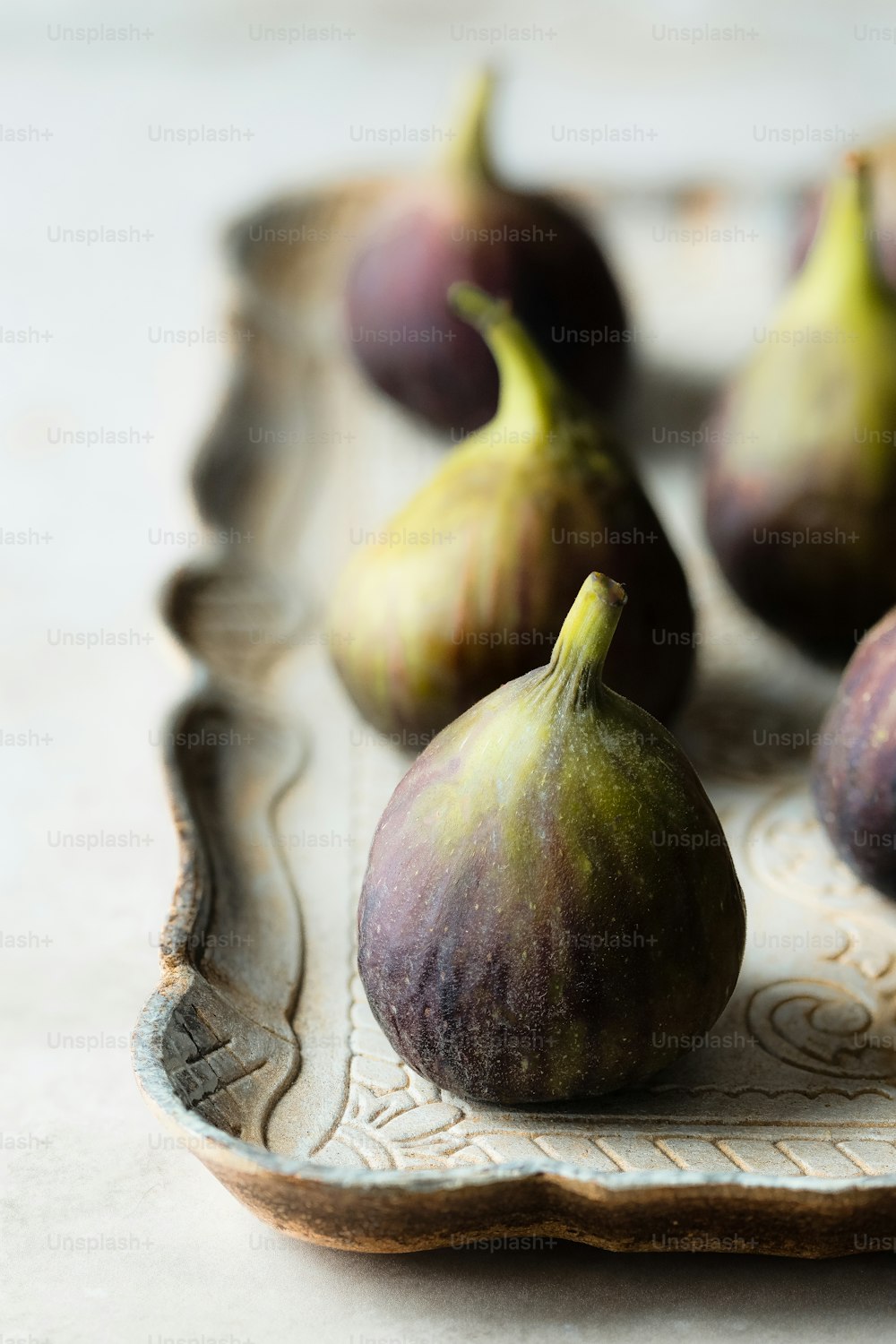some figs are sitting on a plate on a table