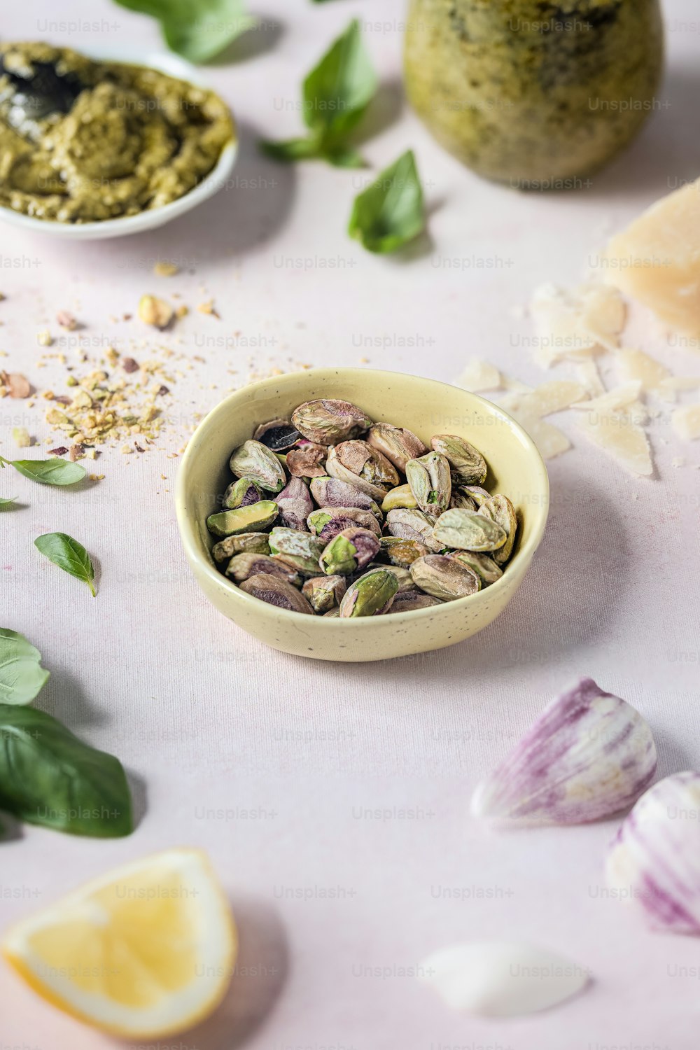 a small bowl of pistachios sits on a table