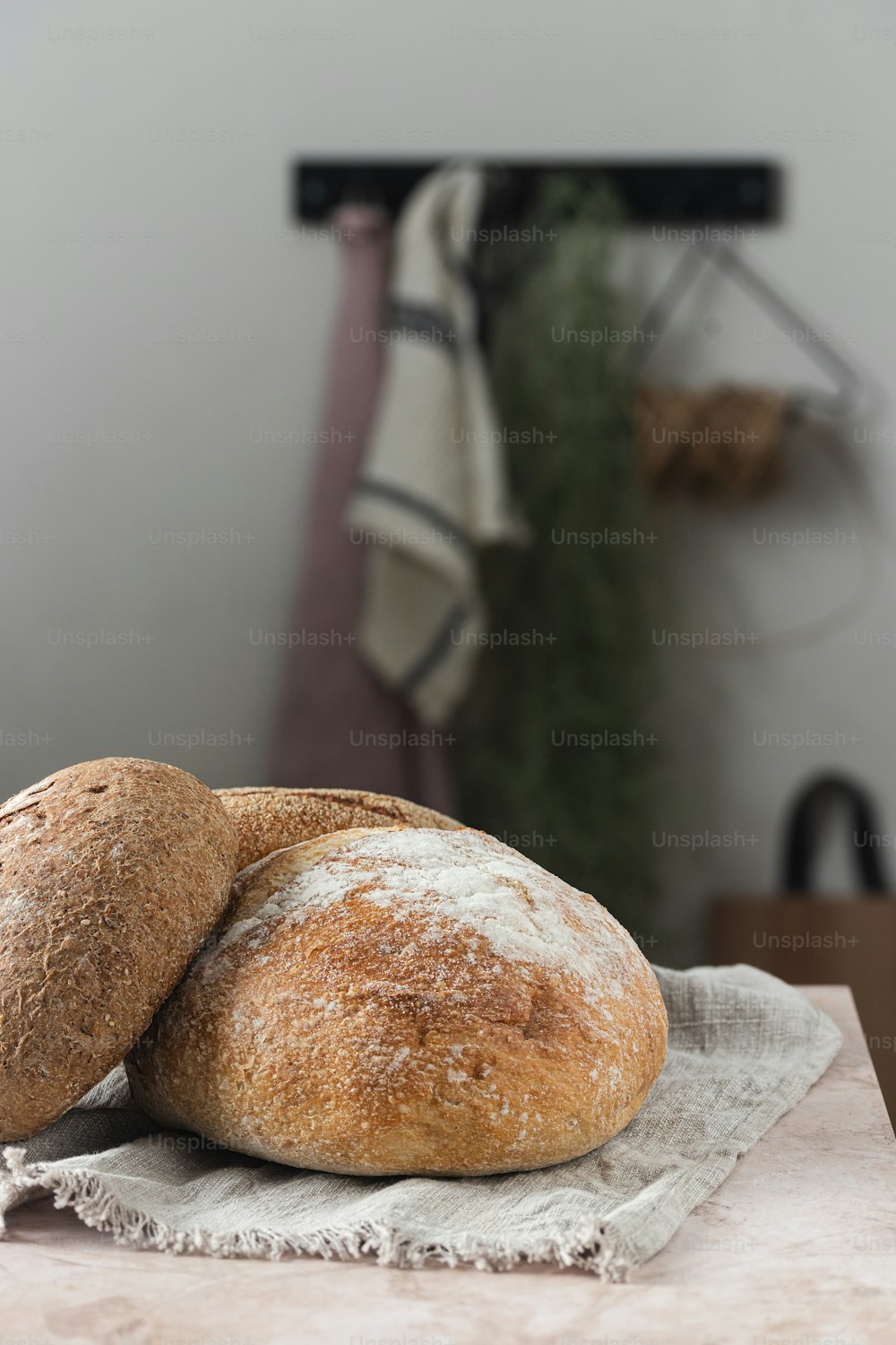 two loaves of bread sitting on top of a cloth