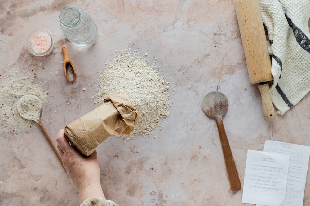 a person holding a piece of paper next to a pile of dirt