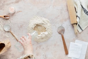 a person is pouring flour into a bowl