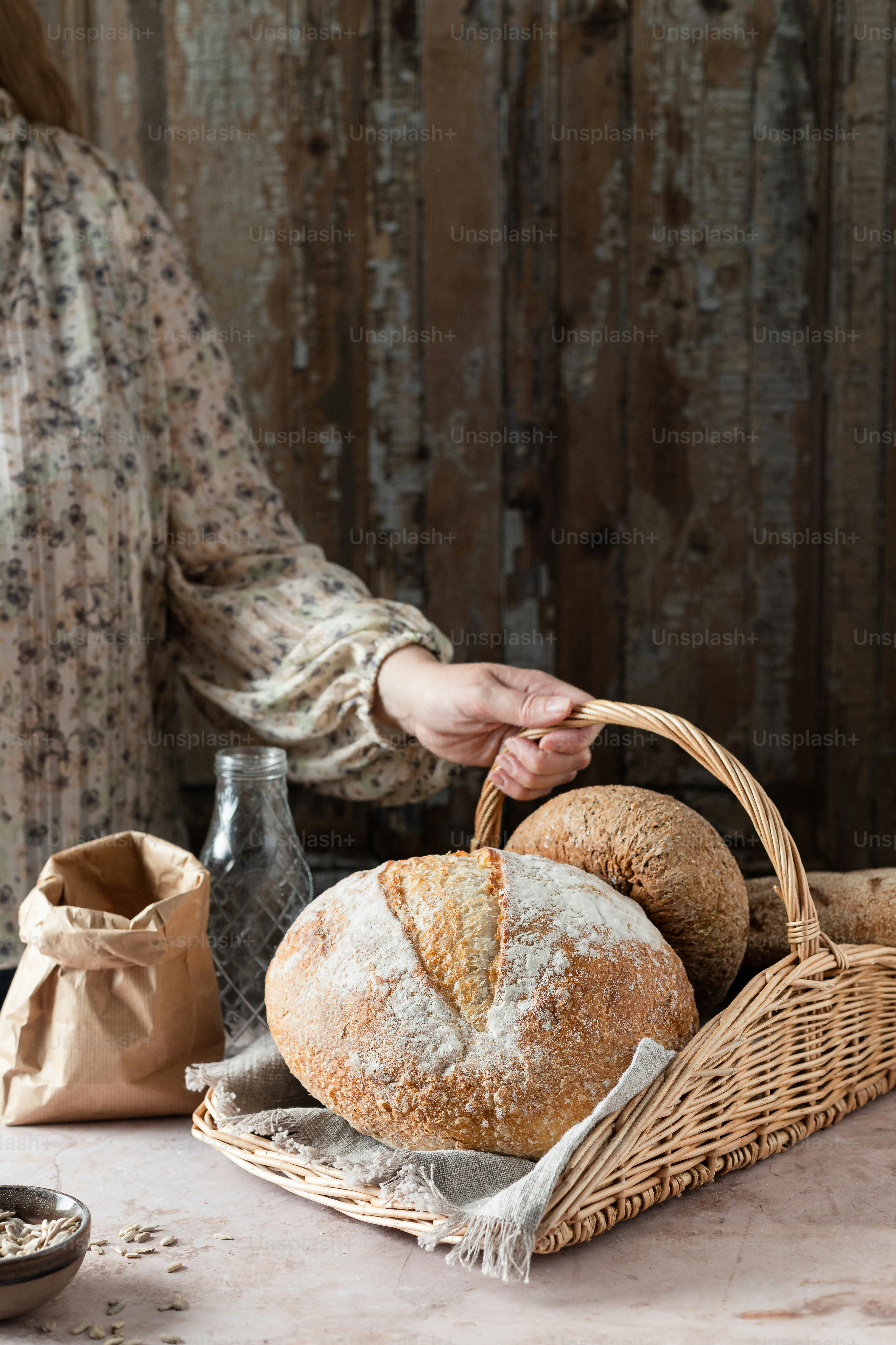 a woman is holding a basket of bread