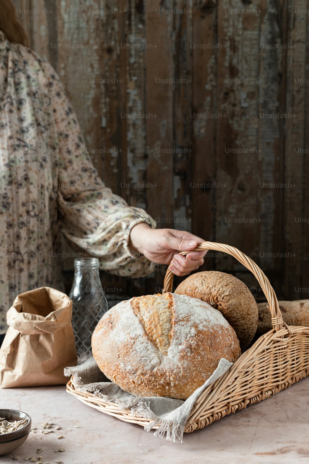 a woman is holding a basket of bread