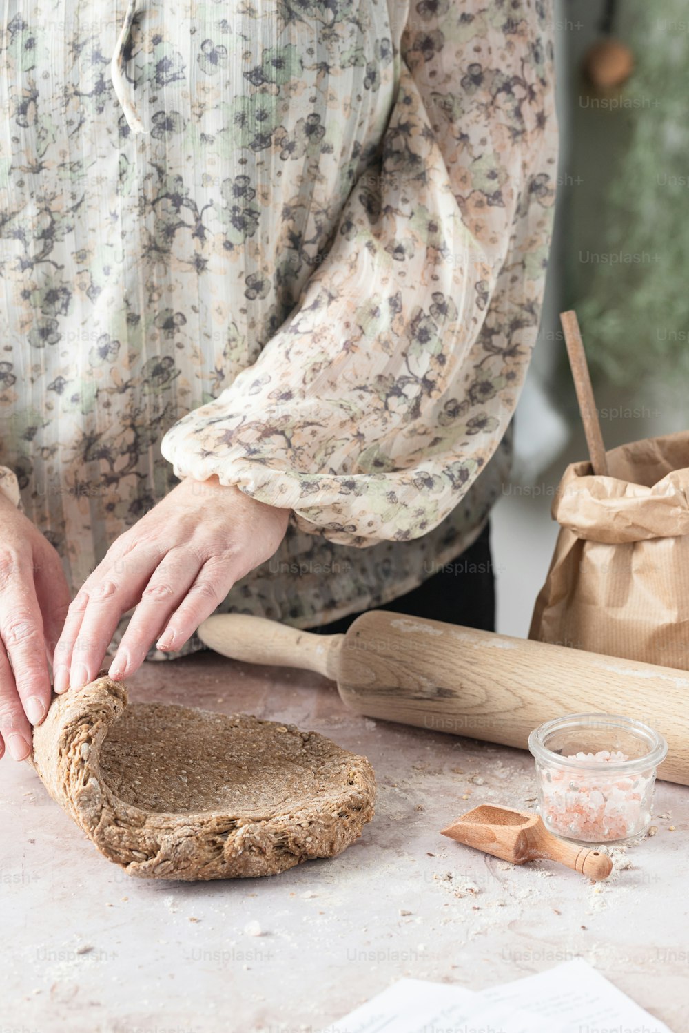 a woman is making bread on a table