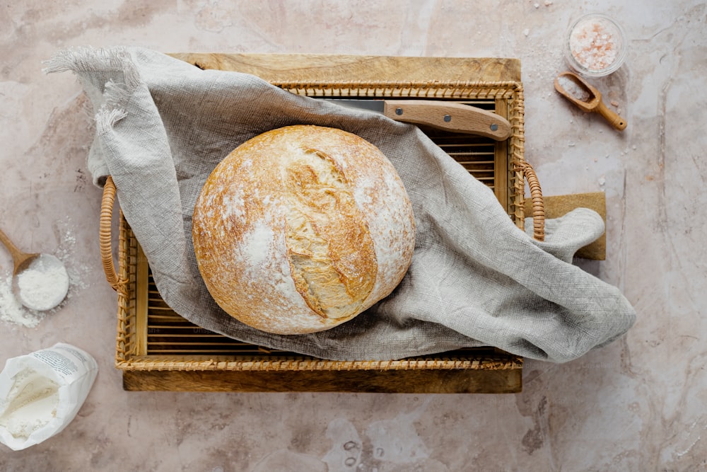 a loaf of bread sitting on top of a wooden tray