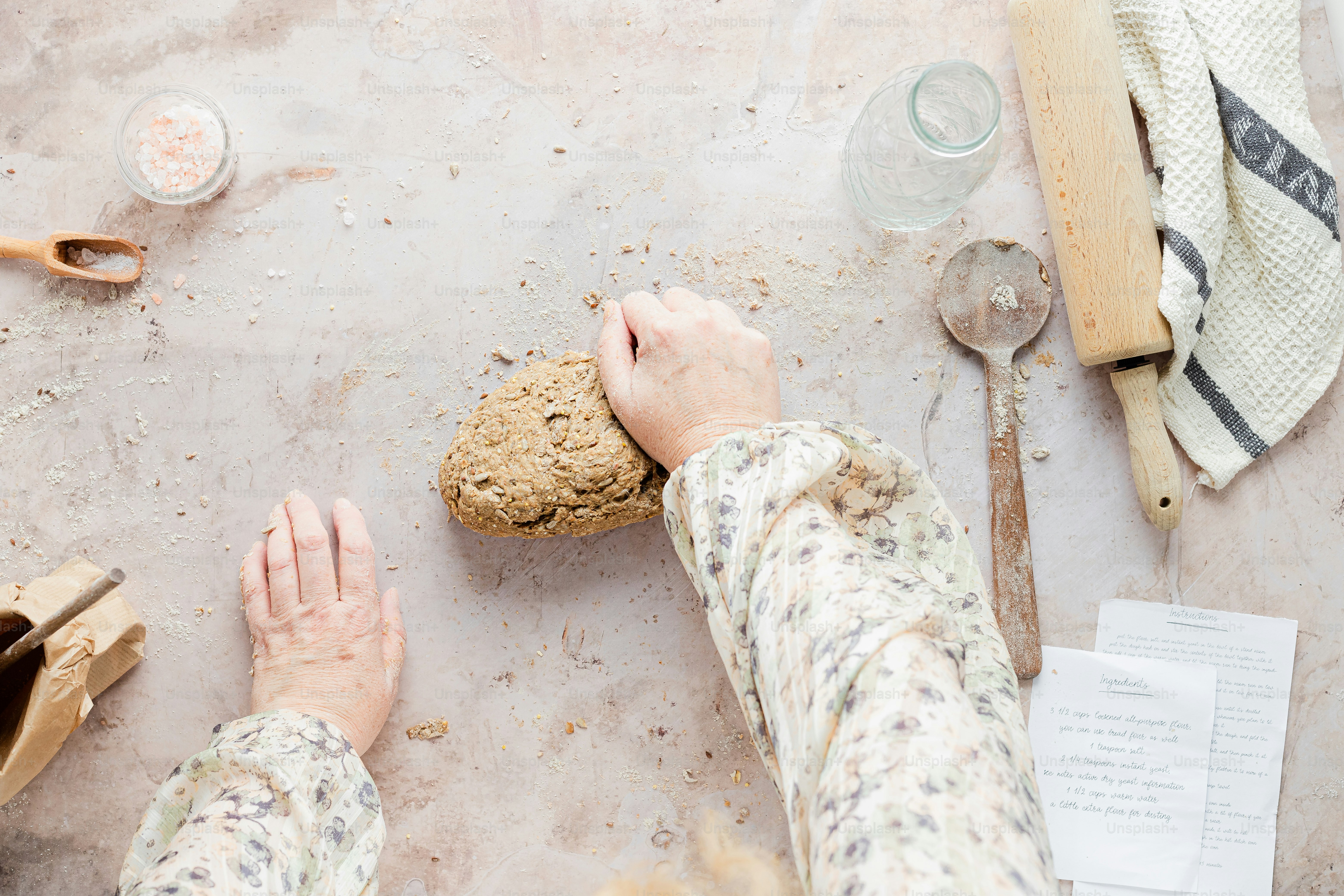 a person holding a cookie on a table
