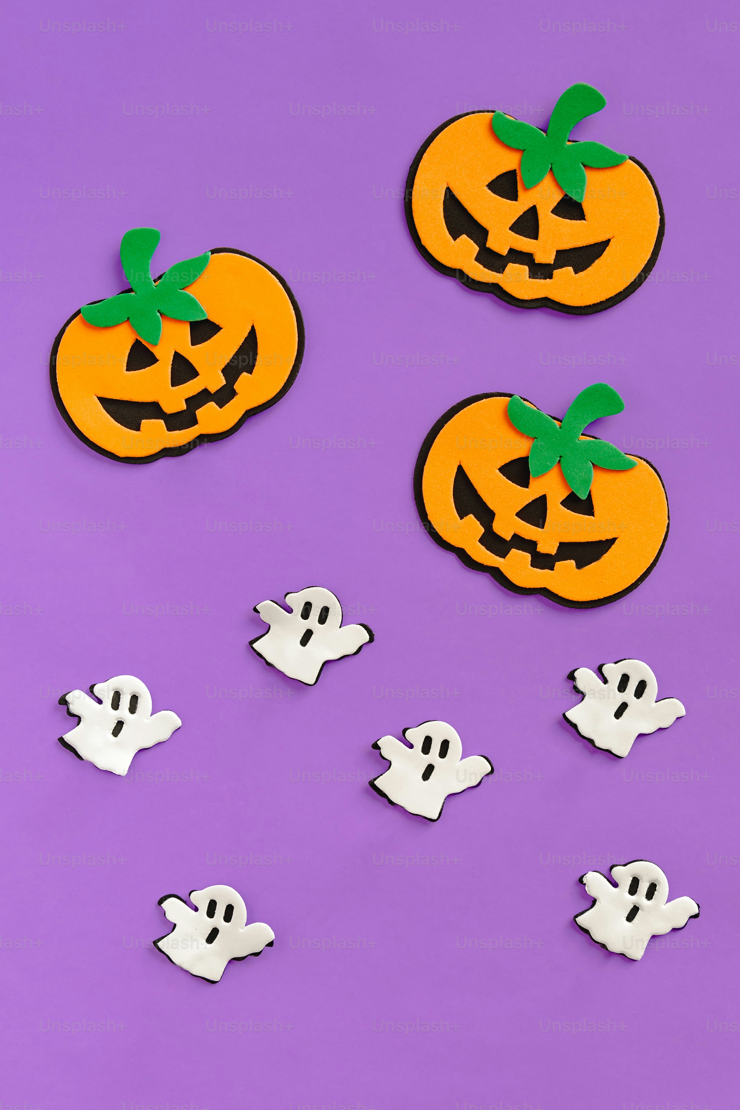 A purple background with a pumpkin and ghost cutouts photo – Wallpaper ...