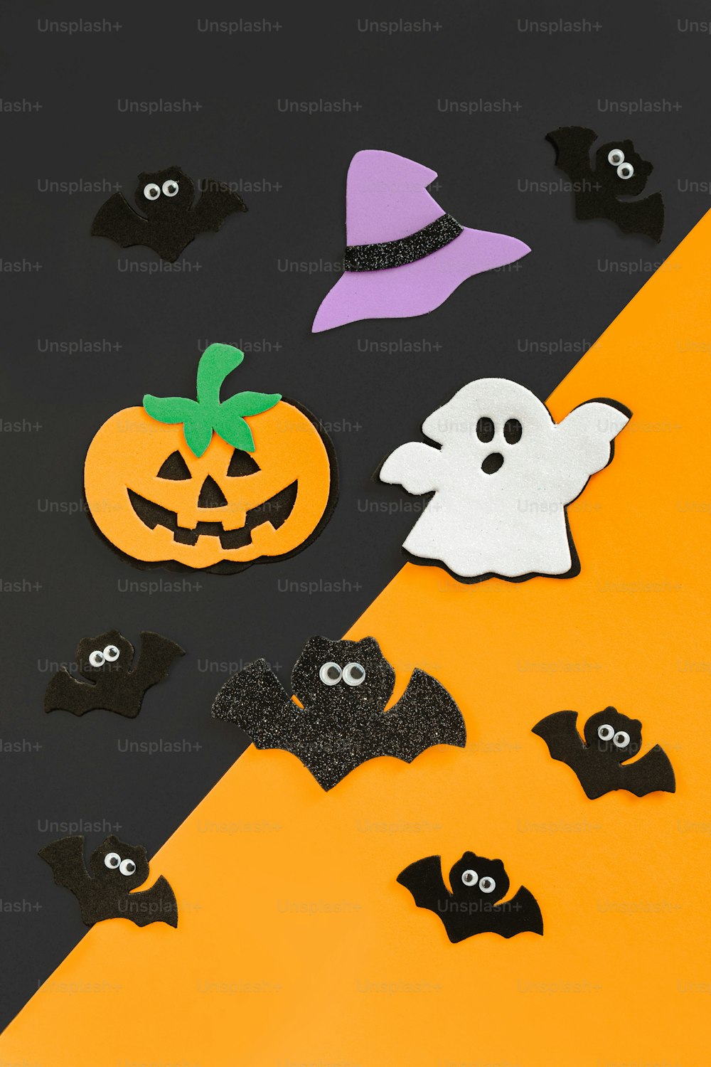 a group of halloween decorations on a black and orange background