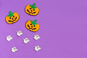 a group of halloween decorations on a purple background