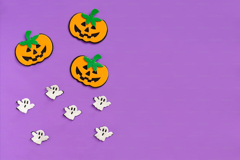 a group of halloween decorations on a purple background