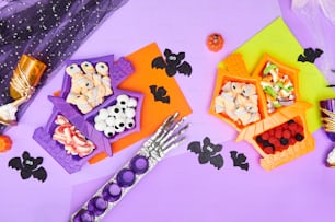 a table topped with lots of halloween treats