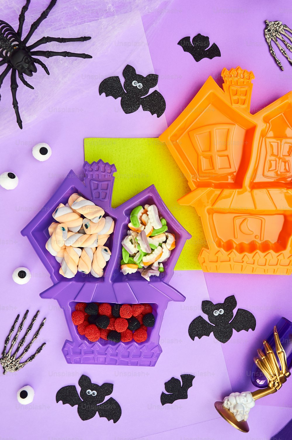 a purple table topped with lots of halloween treats