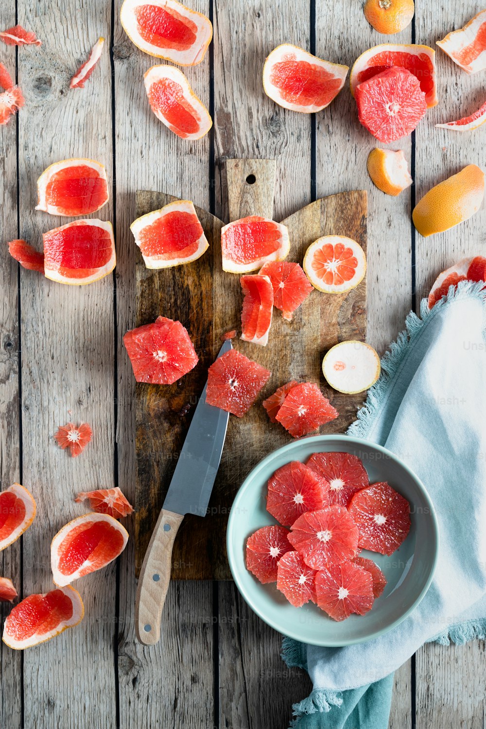 a wooden table topped with slices of grapefruit