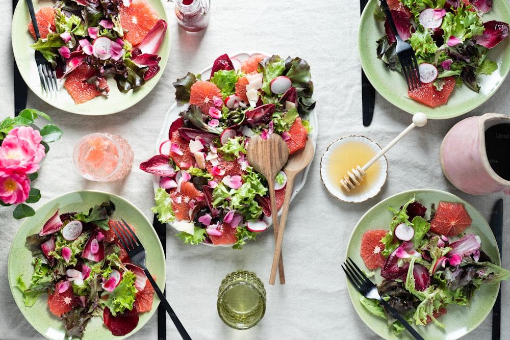 a table topped with plates of food and utensils