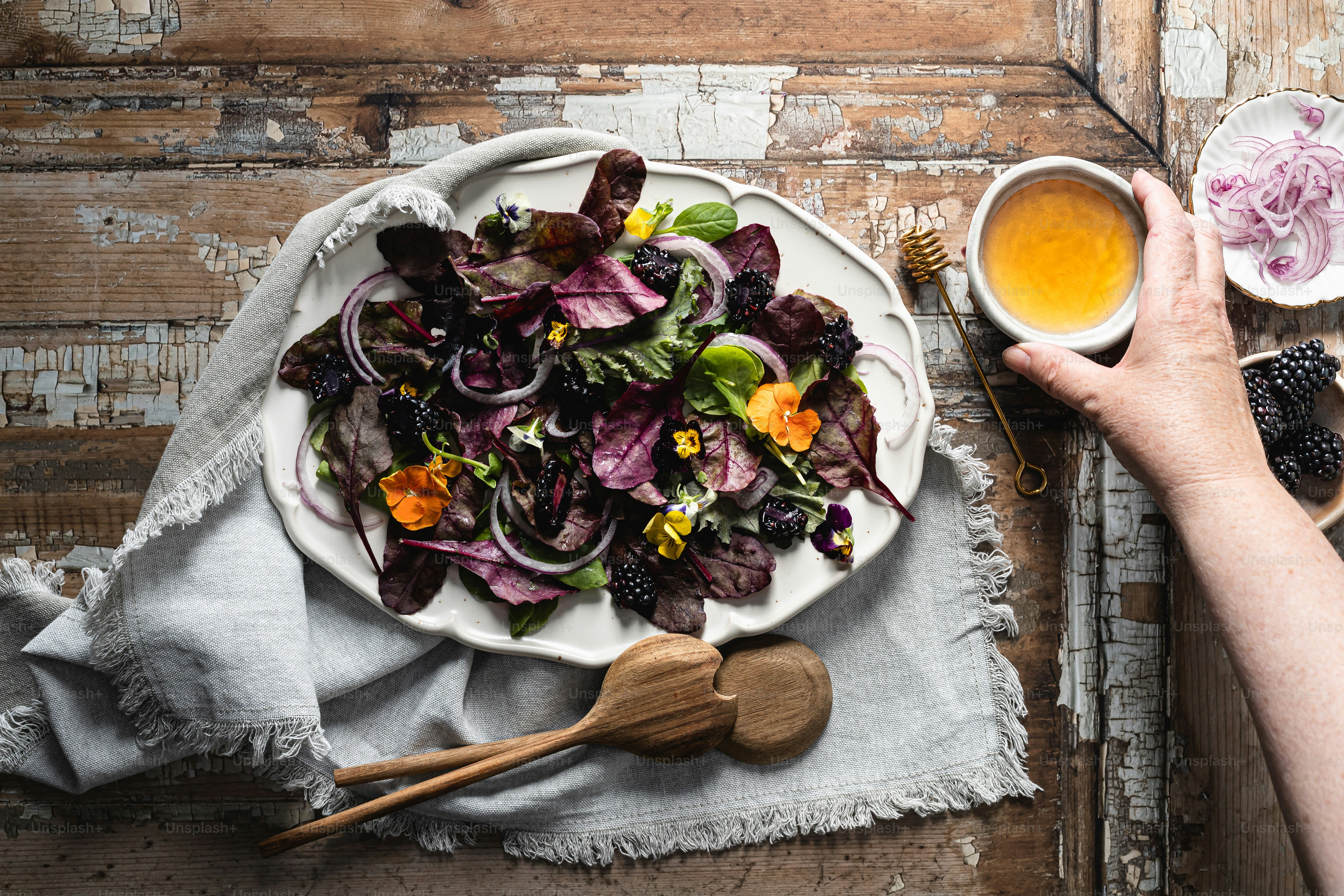 A plate of salad next to a bowl of dressing photo – Food Image on Unsplash