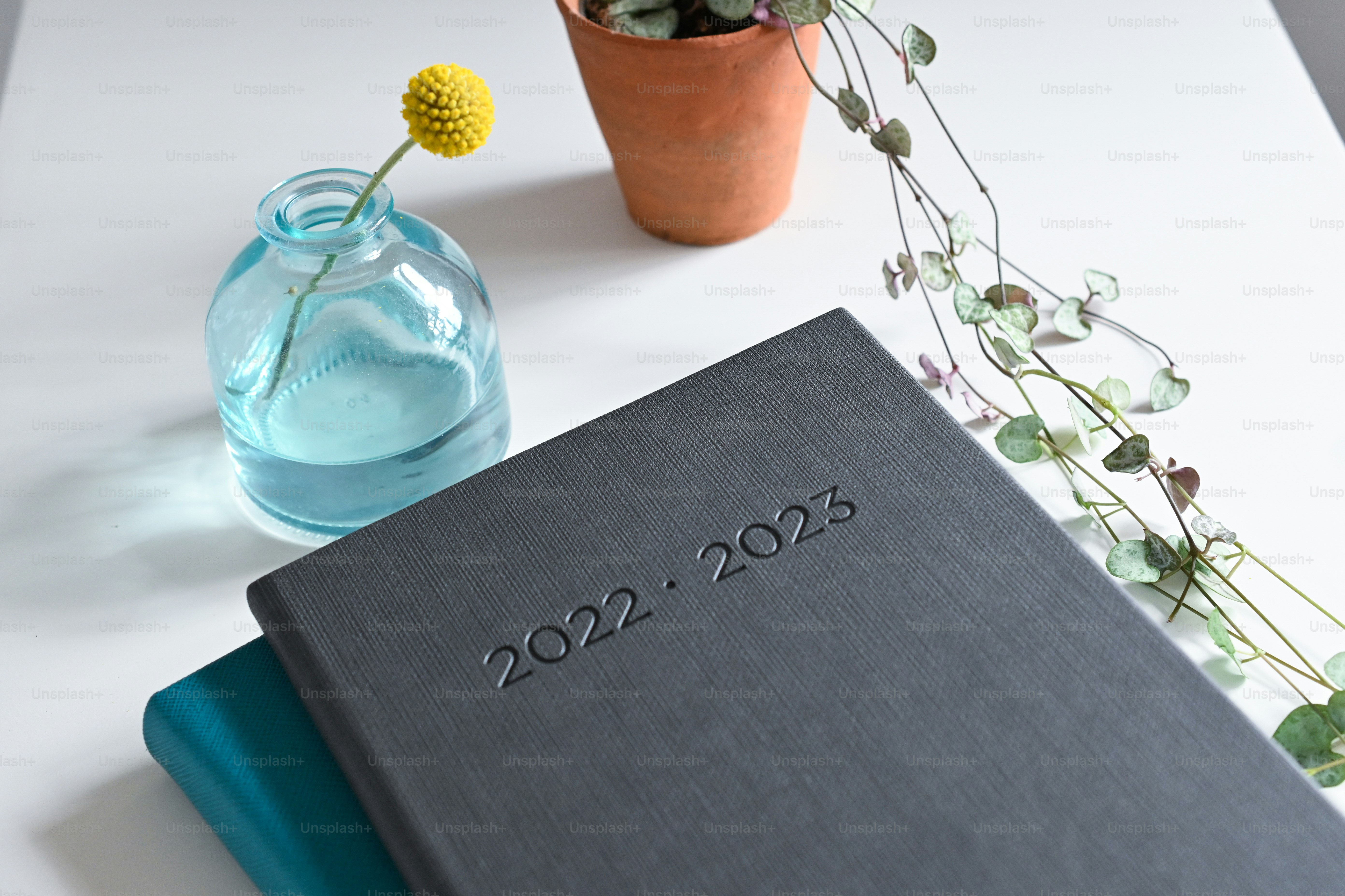 a book sitting on top of a table next to a vase of flowers