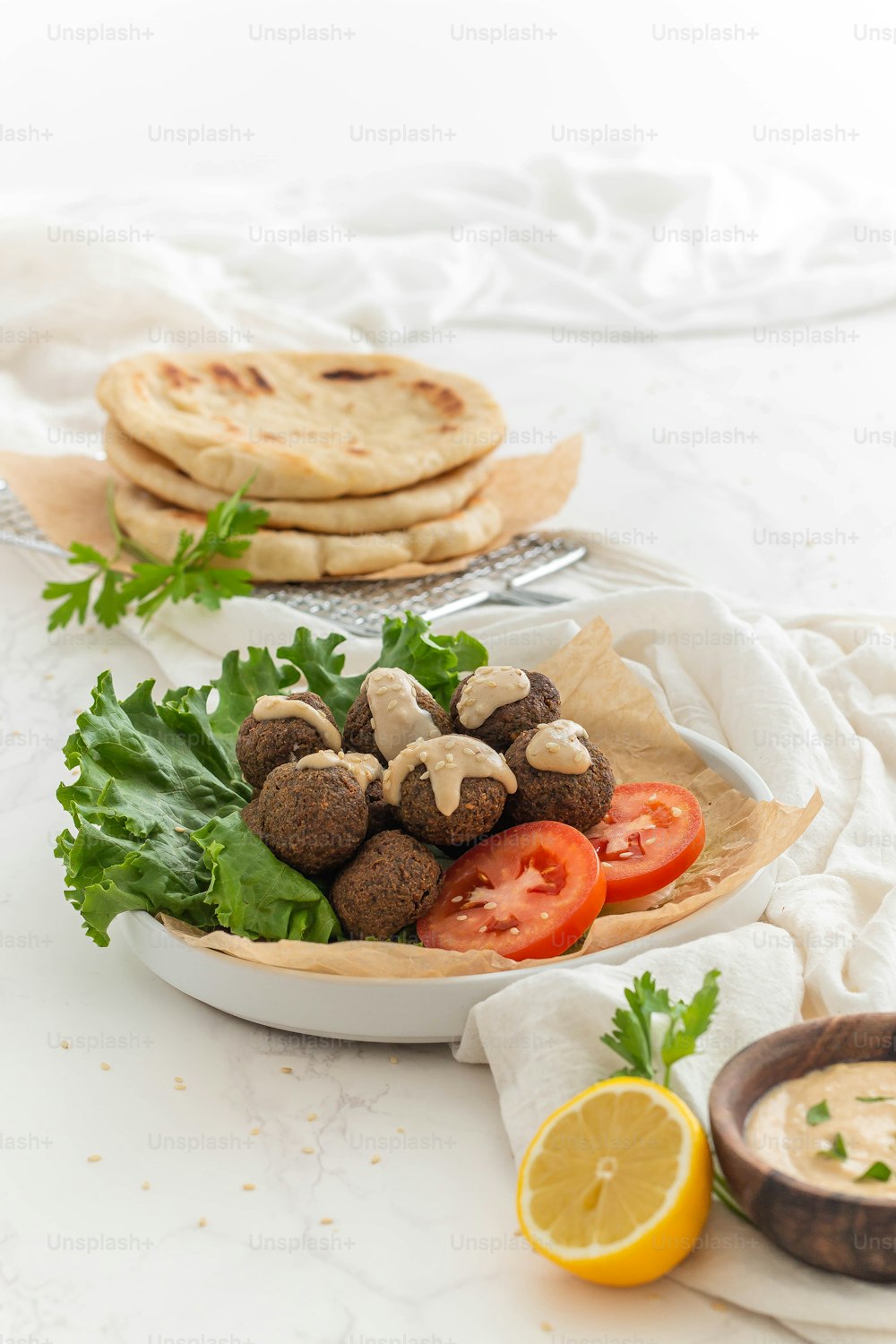 a white plate topped with meatballs and vegetables