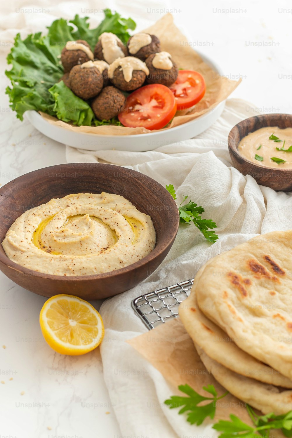 a table topped with plates of food and a bowl of dip