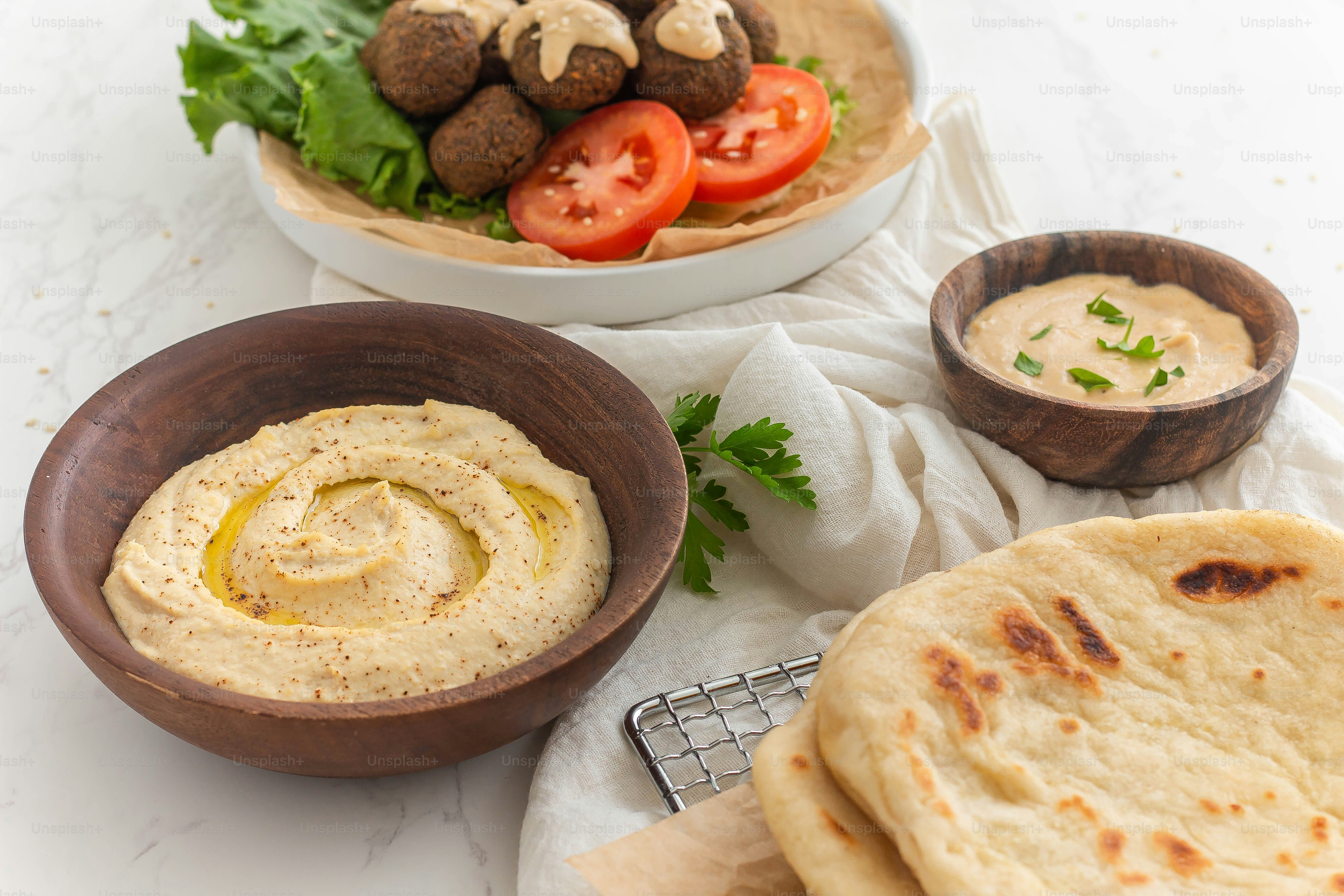 a plate of pita bread and a bowl of pita bread
