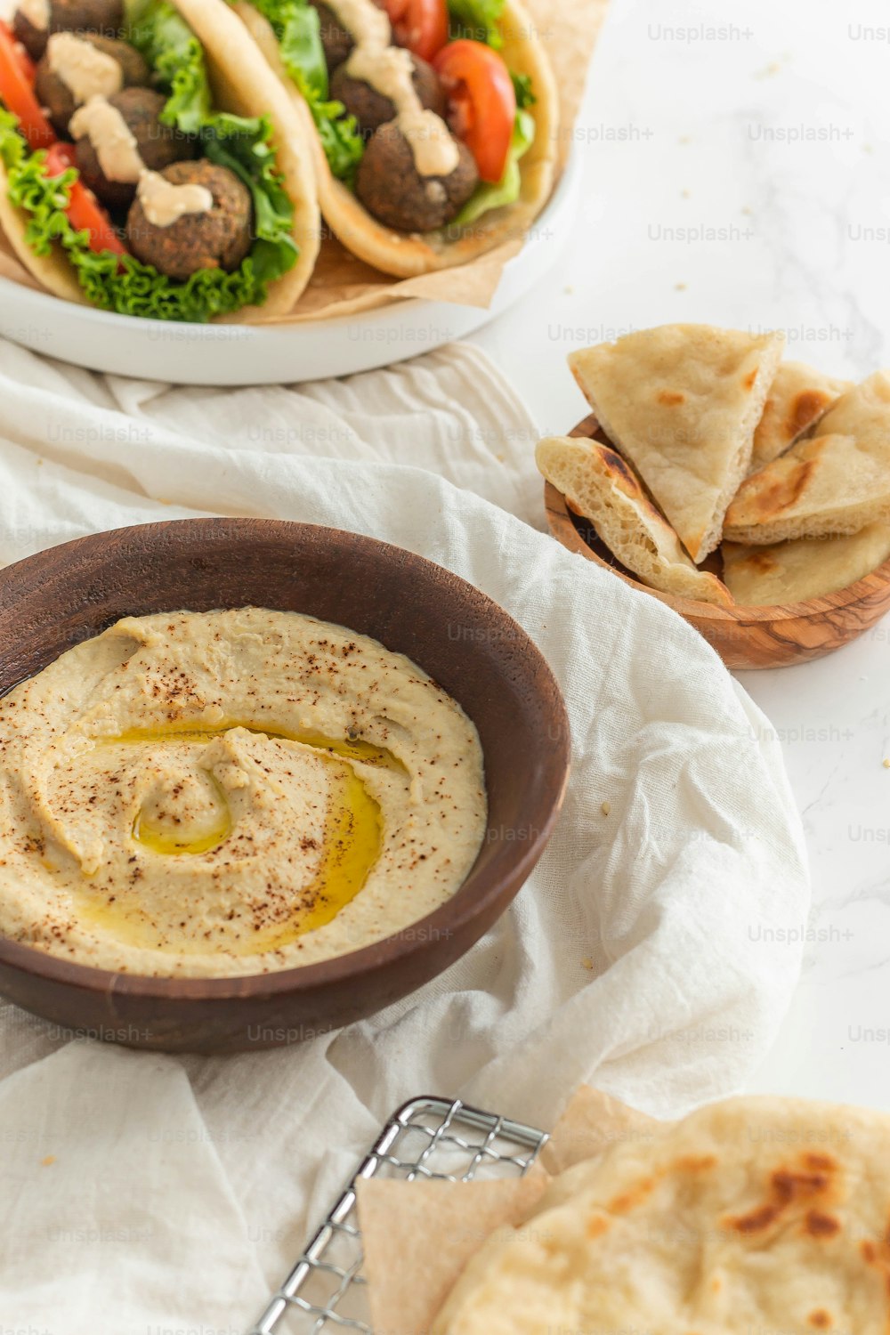 a bowl of hummus and pita bread on a table