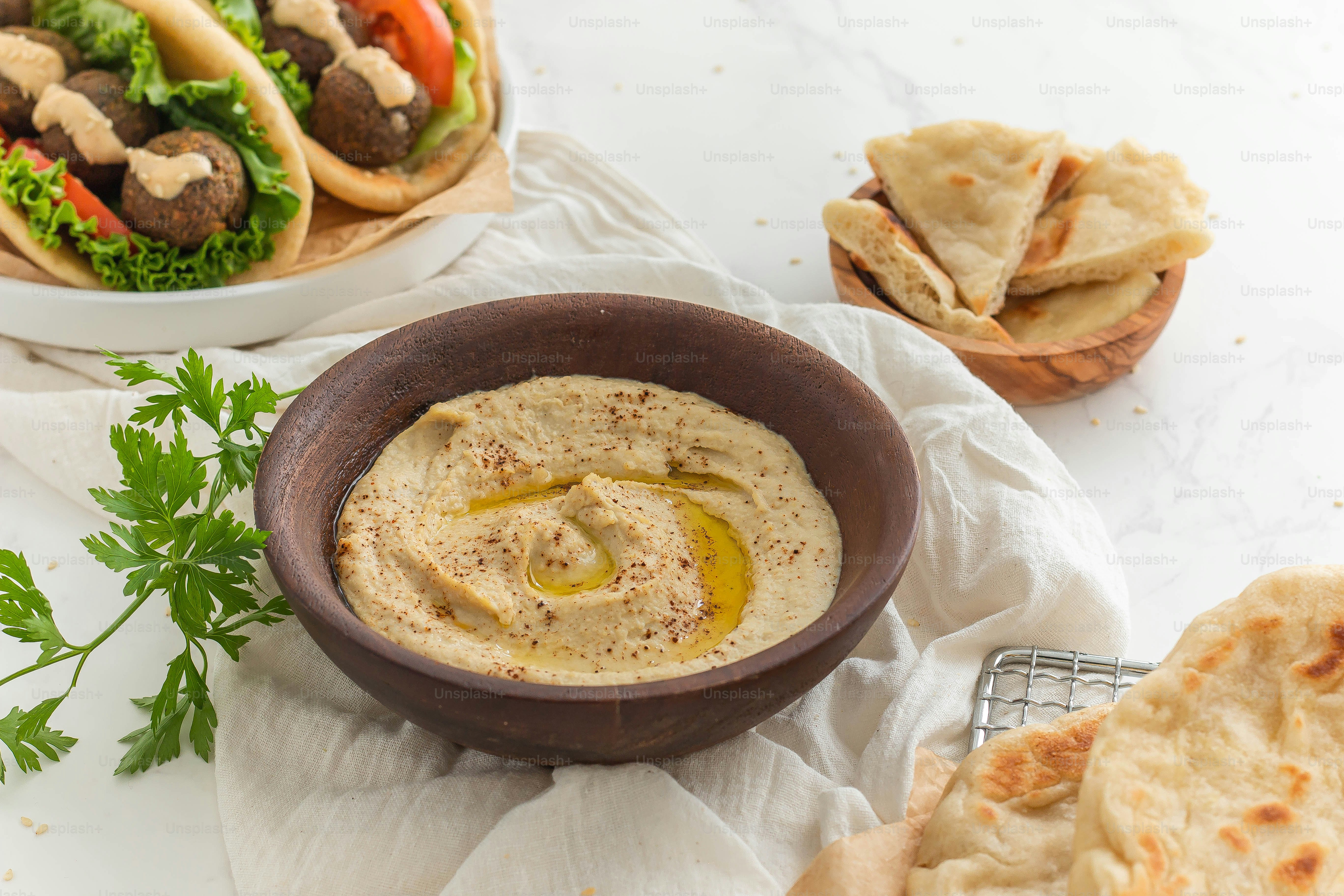 A bowl of hummus and pita bread on a table photo – Healthy Image on ...