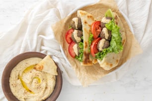 ein Teller mit Fladenbrot und eine Schüssel Hummus