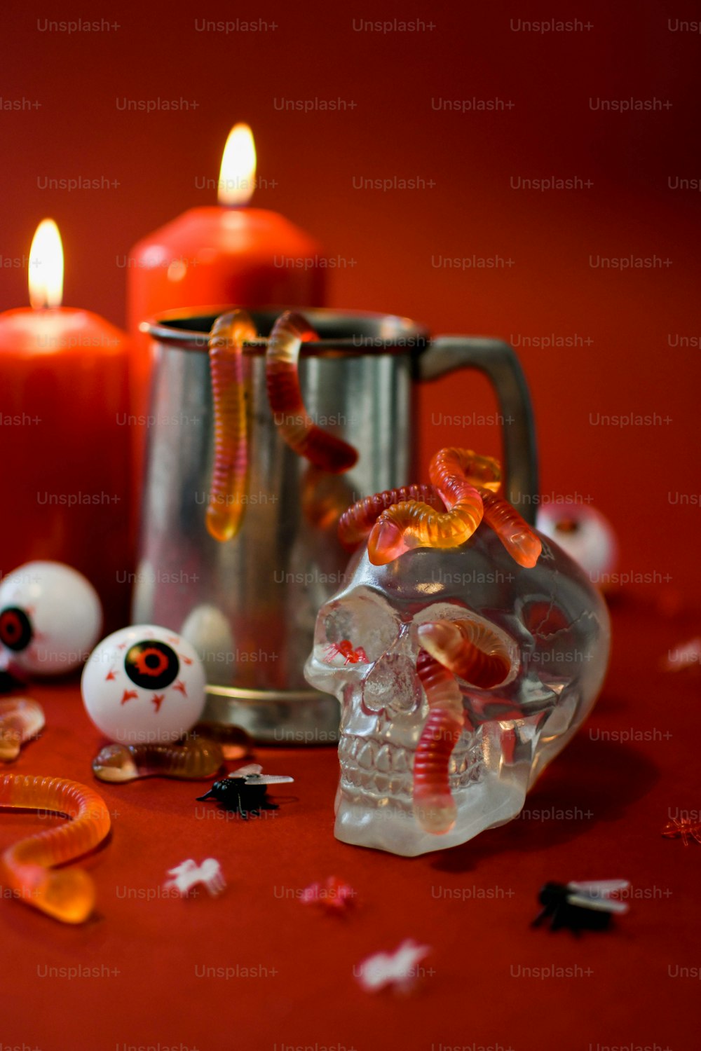 a table topped with candles and a skull figurine