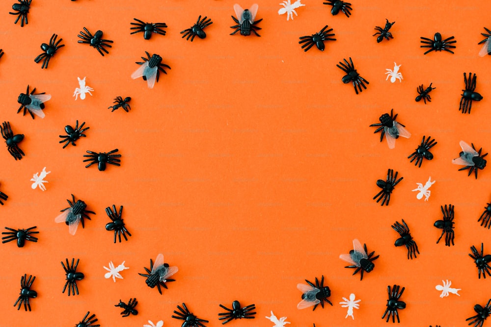 a group of black and white flowers on an orange background