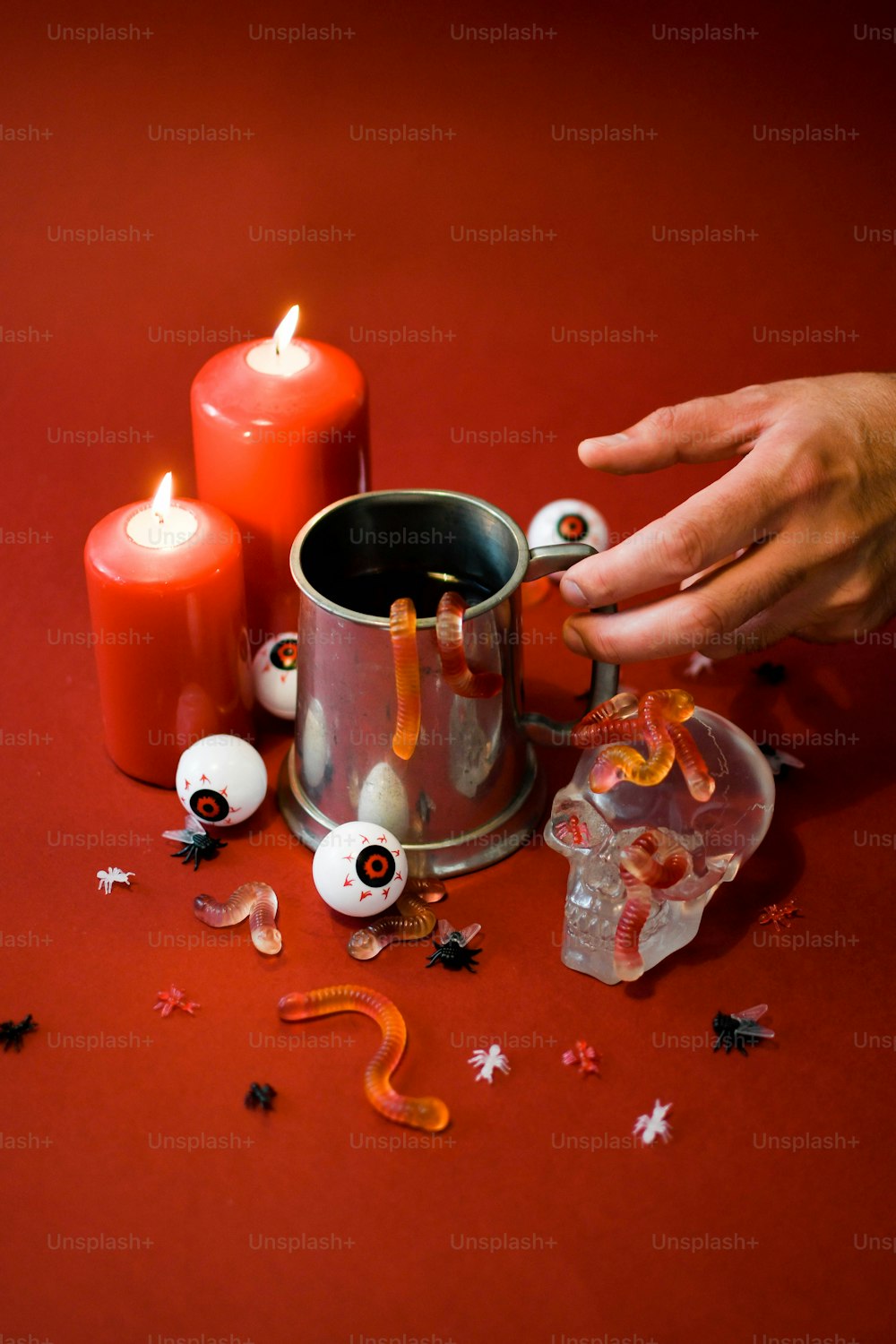 a person lighting candles on a red table