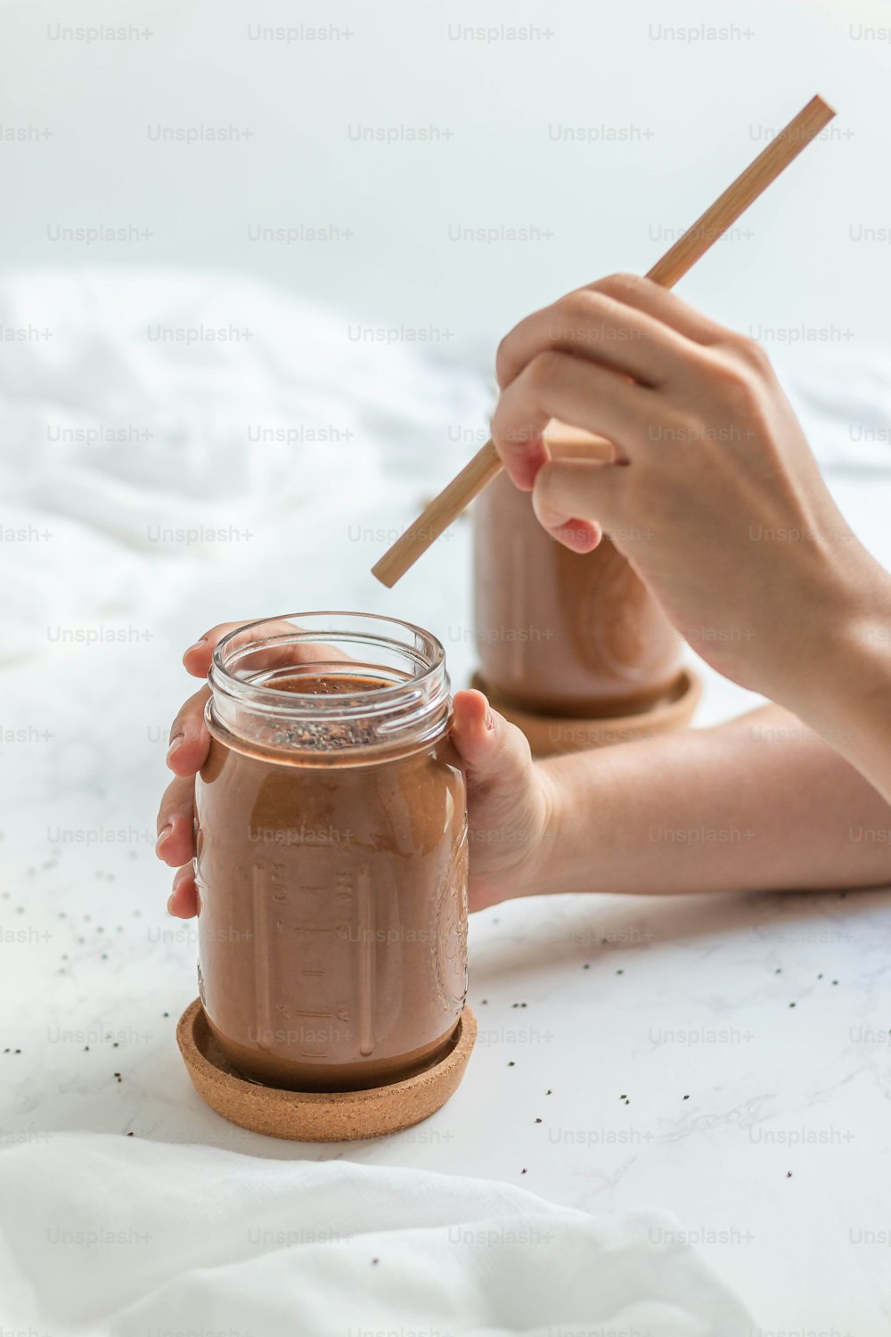 a person is holding a jar of chocolate