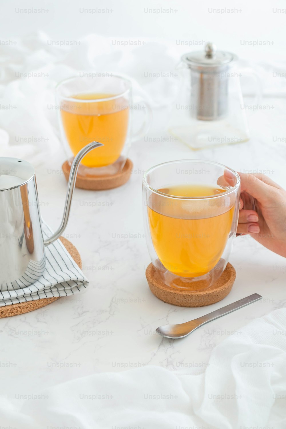 a person is holding a cup of tea