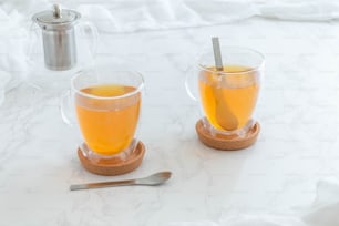 two cups of tea on a marble table