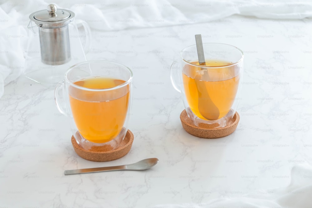 two cups of tea on a marble table
