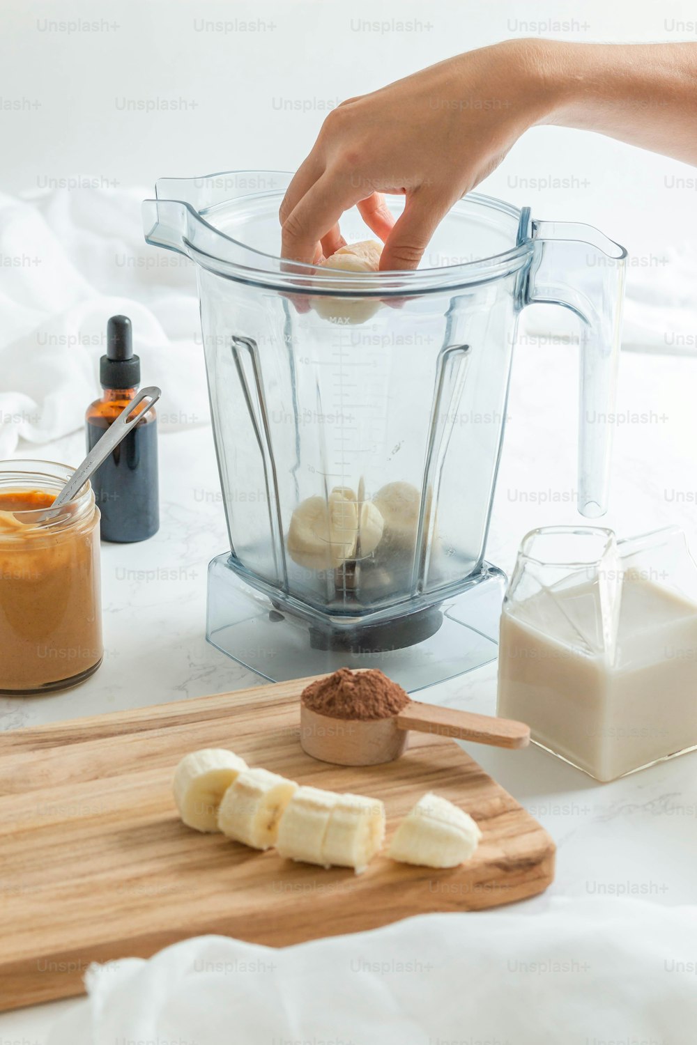 a person is making a banana smoothie in a blender