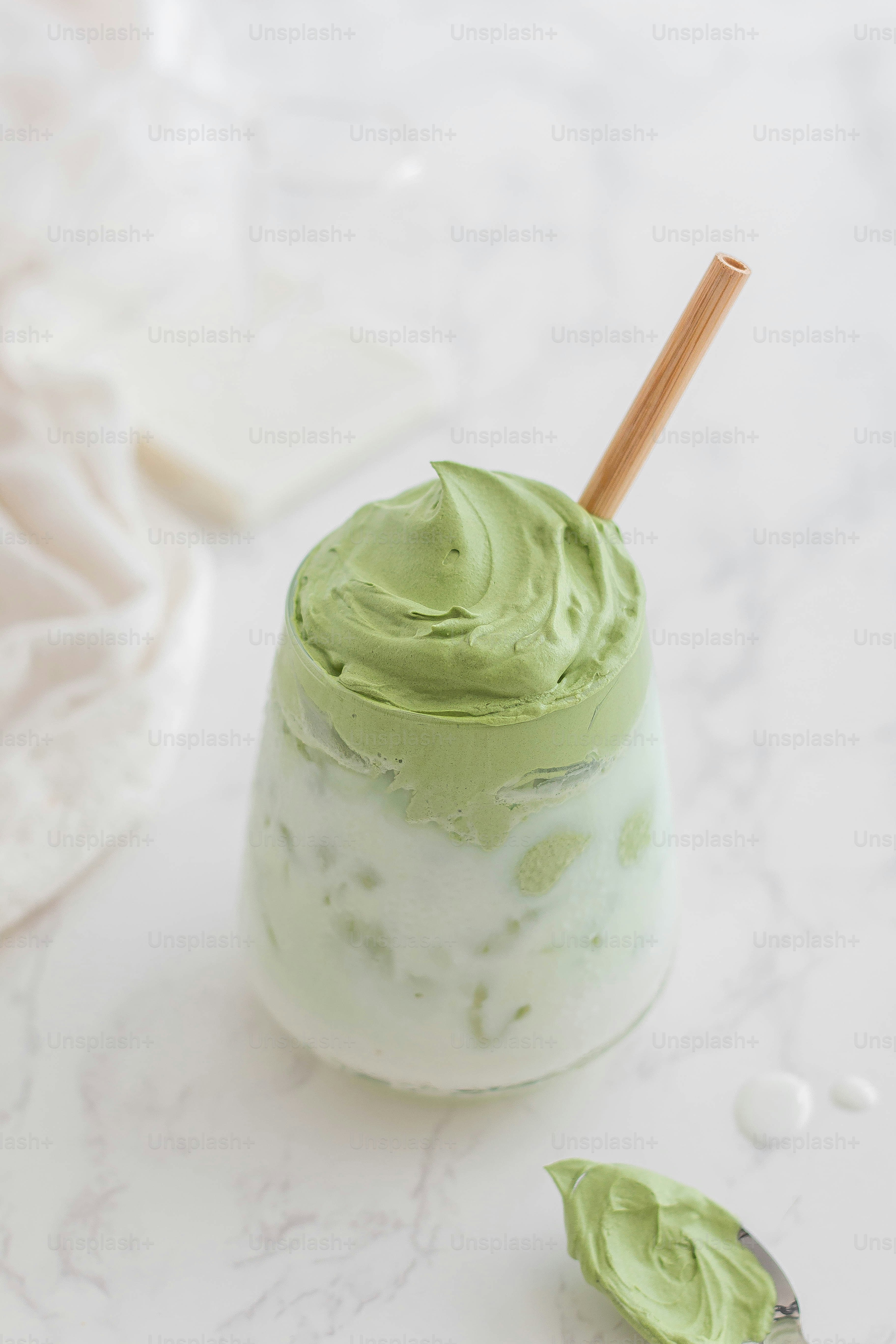 A small jar of green whipped cream with a wooden spoon photo – Healthy ...