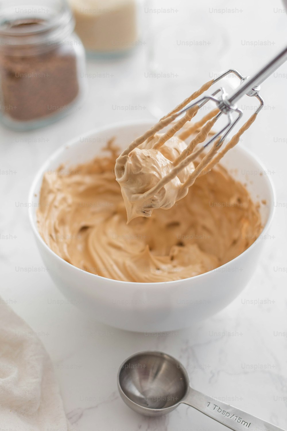 a whisk in a bowl with peanut butter