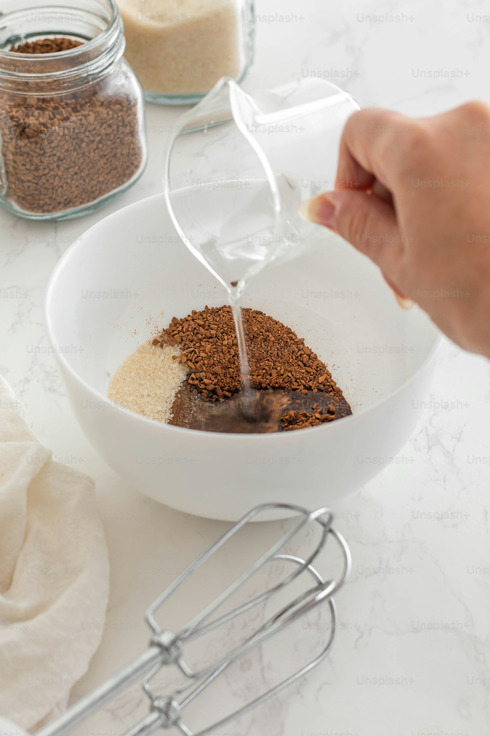 a person pouring a mixture into a bowl