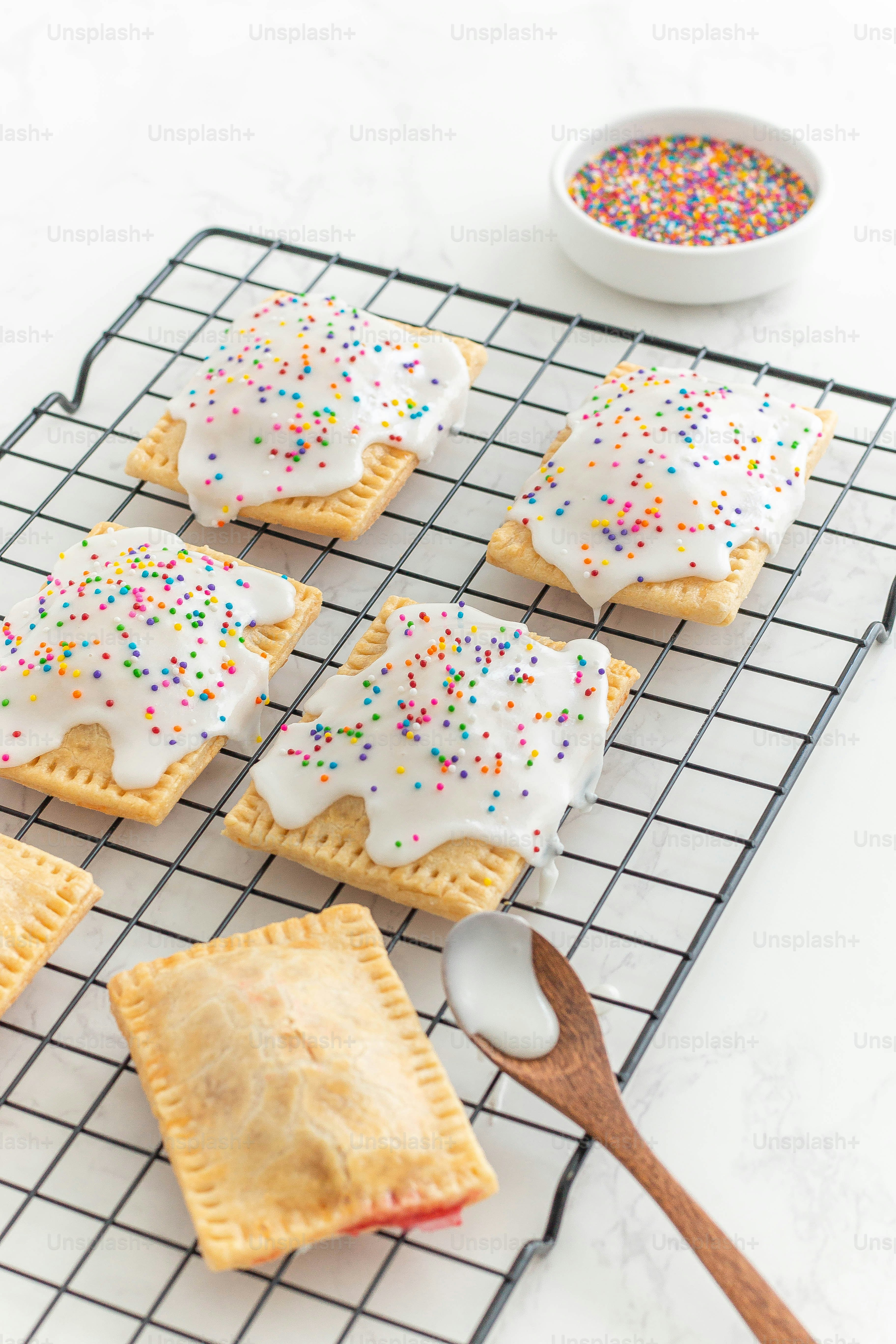 a cooling rack with cookies and sprinkles on it