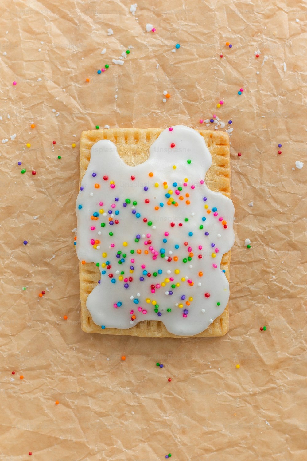 a cookie with sprinkles on a piece of paper