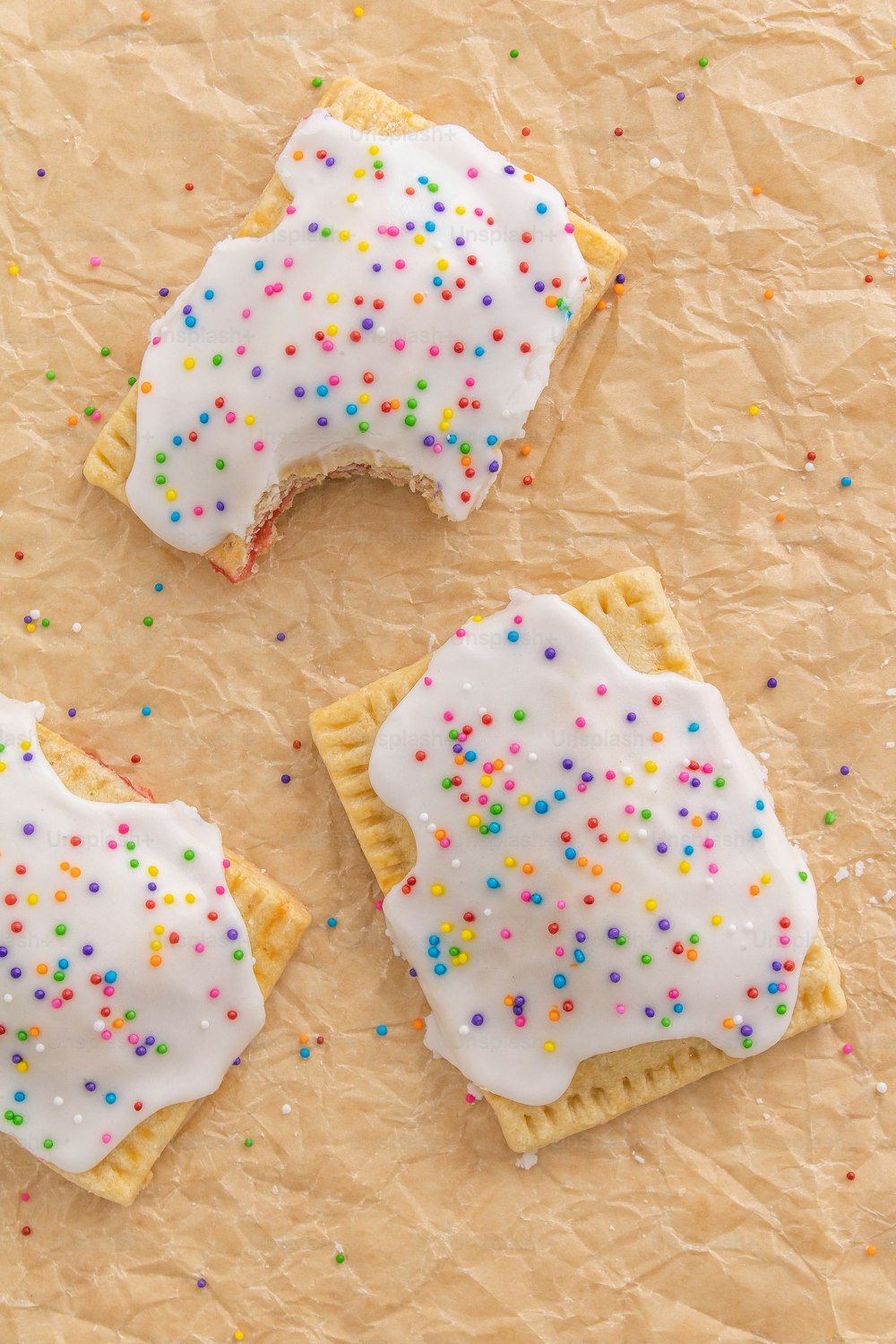 three decorated cookies on a piece of paper