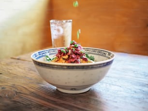 a bowl of food on a wooden table