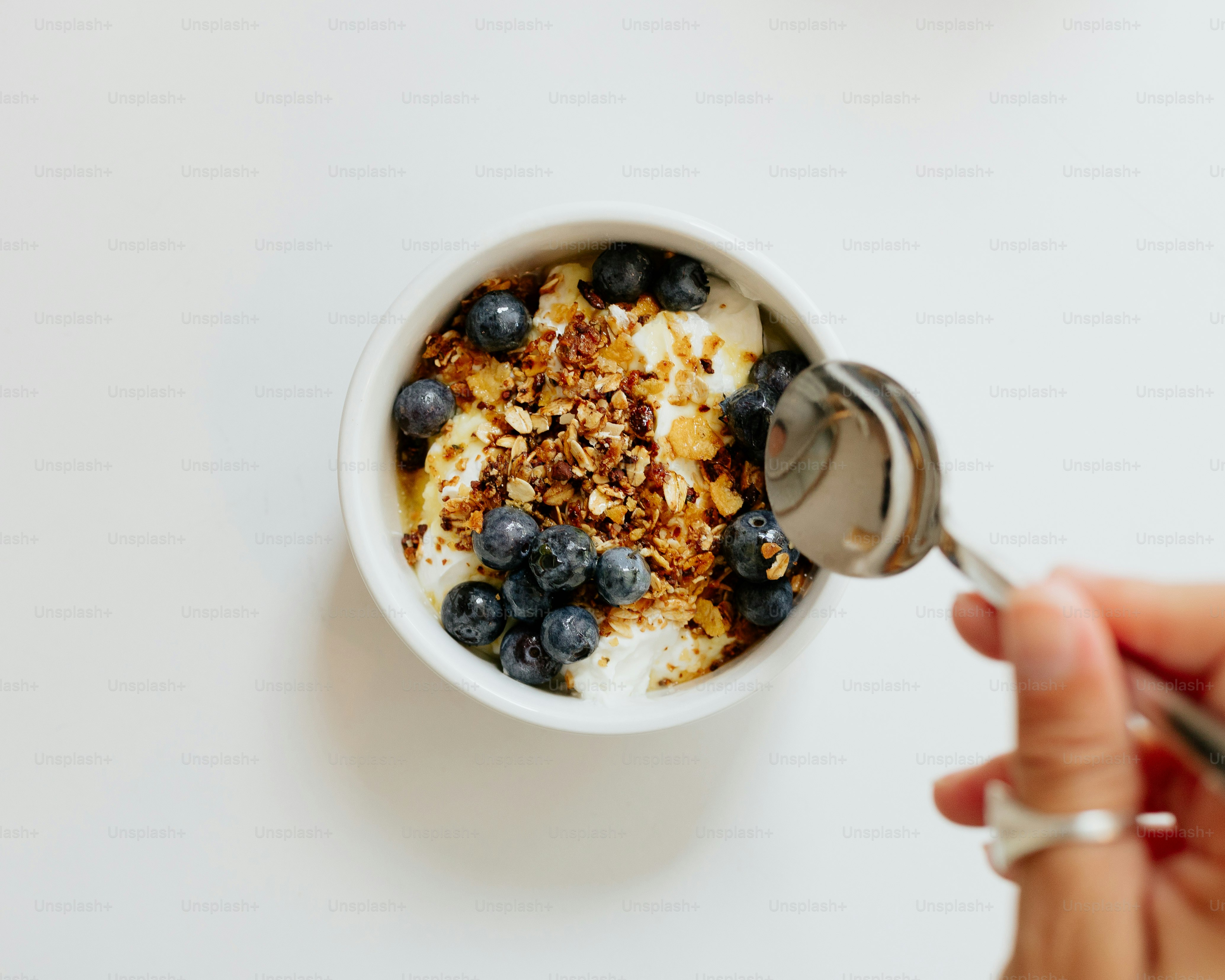 a bowl of cereal with blueberries and granola